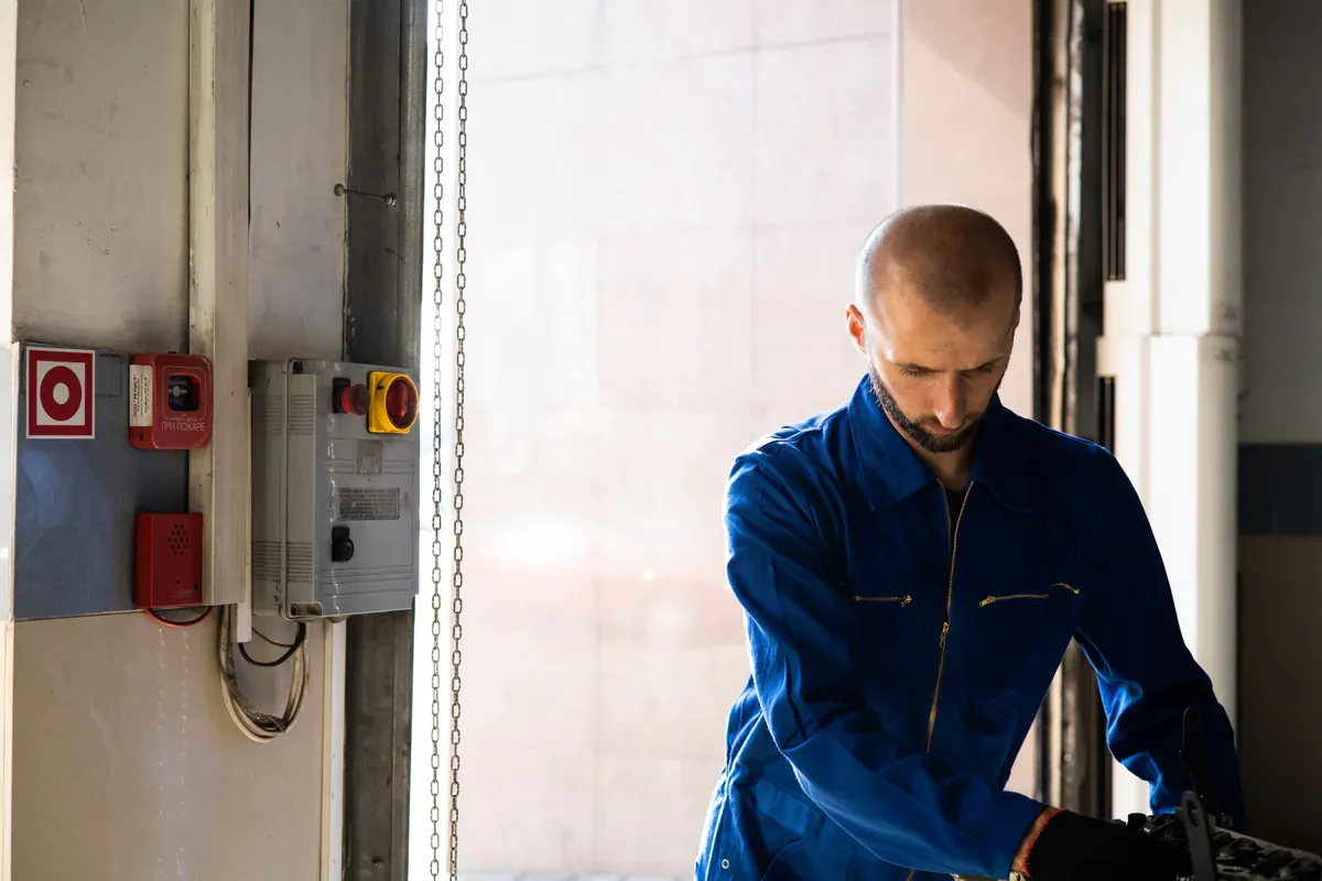 Technician checking industrial equipment during fault diagnosis