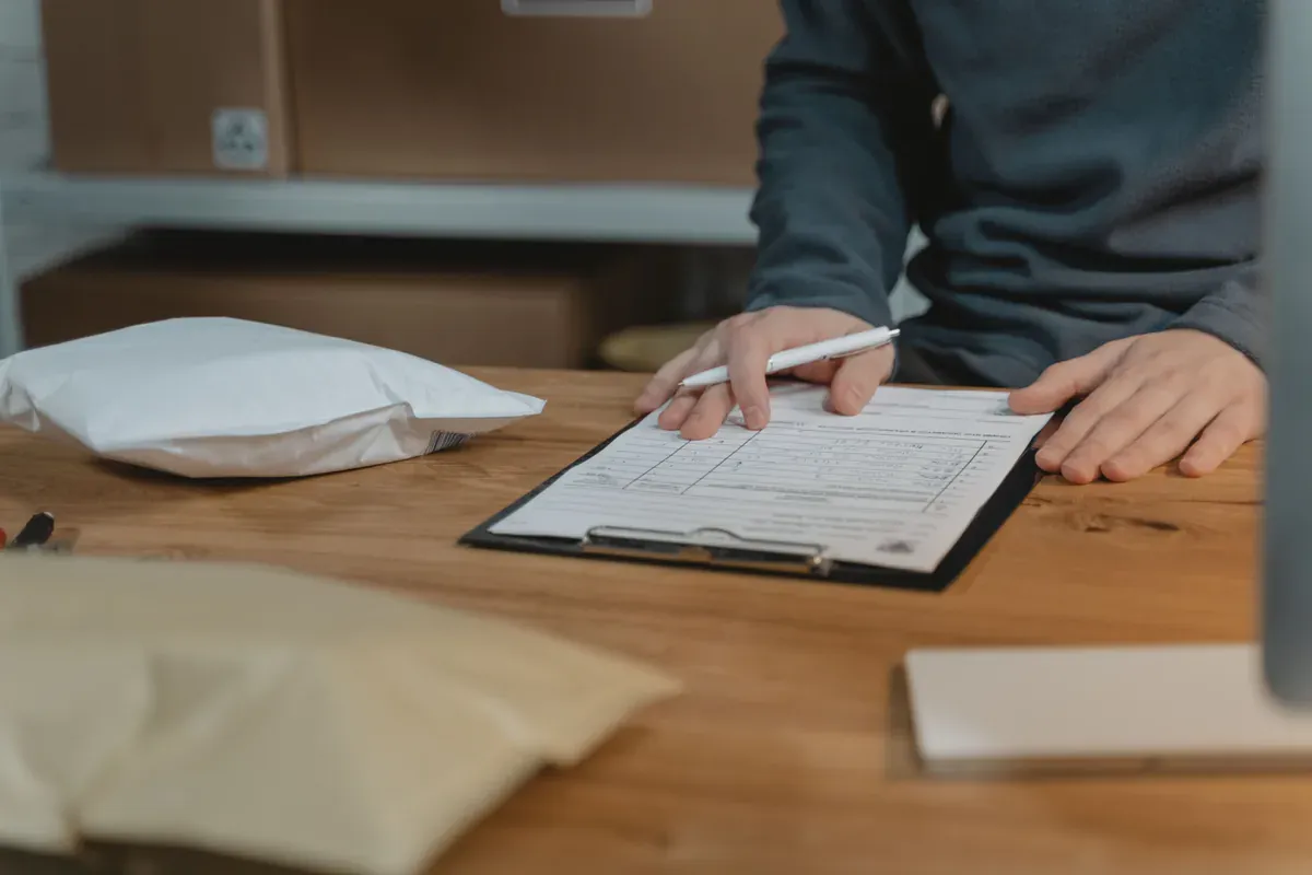 Shipping documentation being completed beside packaged goods