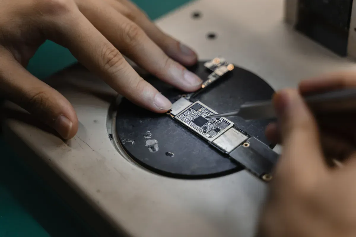 Technician performing precision work on small electronic components