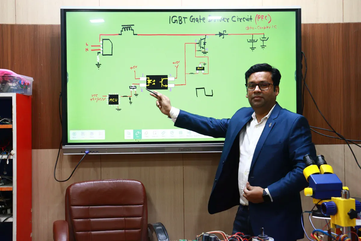 Engineer explaining an IGBT gate-driver circuit for power conversion