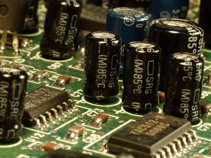 Capacitors on a power board illustrating stored energy and inrush-current budgeting