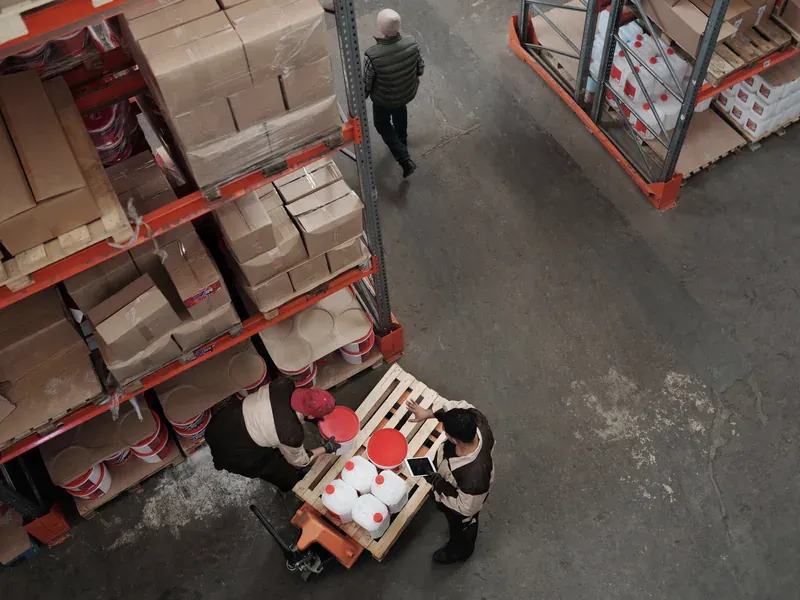 Warehouse worker visually inspecting a sealed shipment