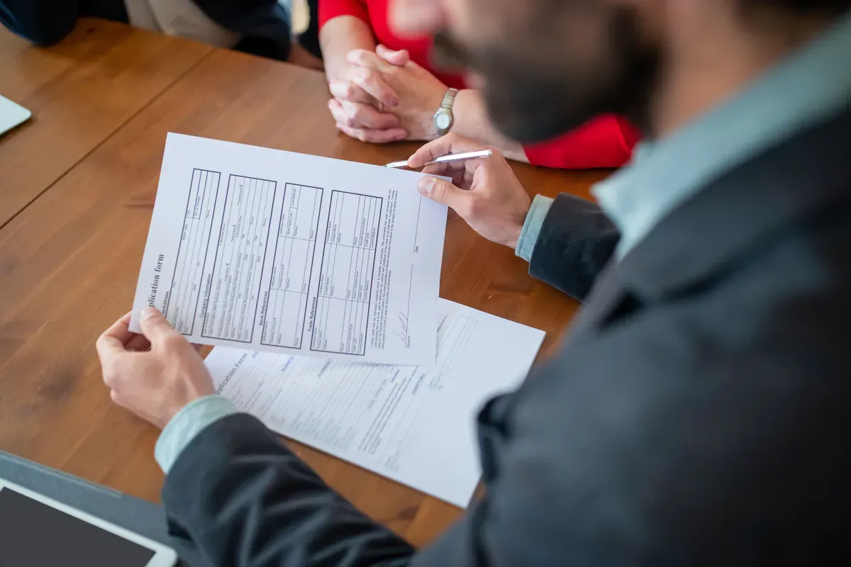 Business professionals reviewing commercial contract terms at a meeting