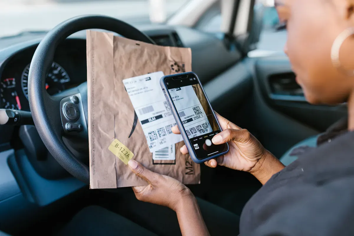 Package label being scanned during a delivery handoff