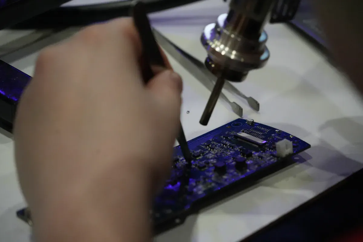 Close view of a QFN integrated circuit at an electronics rework station