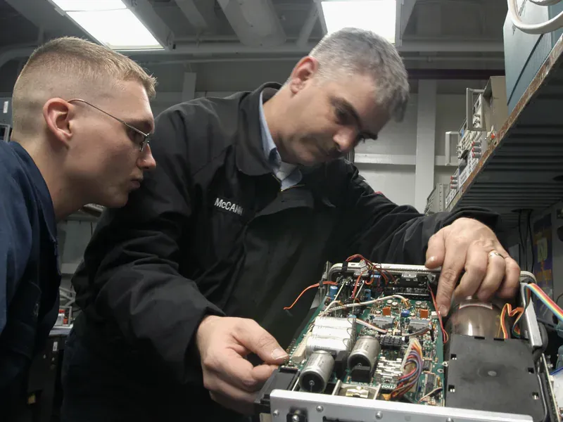 Technicians calibrating an oscilloscope for electrical measurements