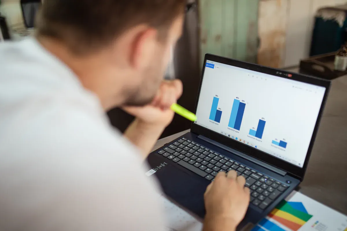 Market data and purchasing scenarios being reviewed on a laptop