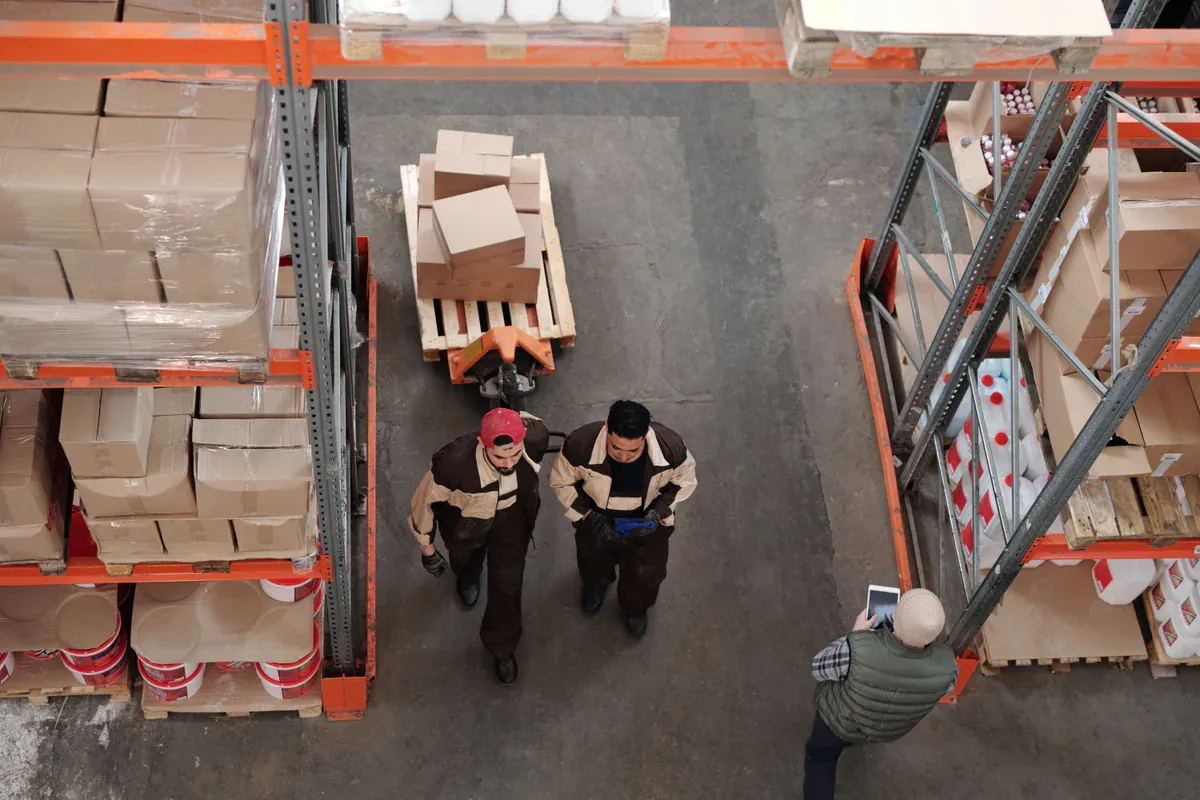 Warehouse team preparing packaged goods for shipment and landed-cost review
