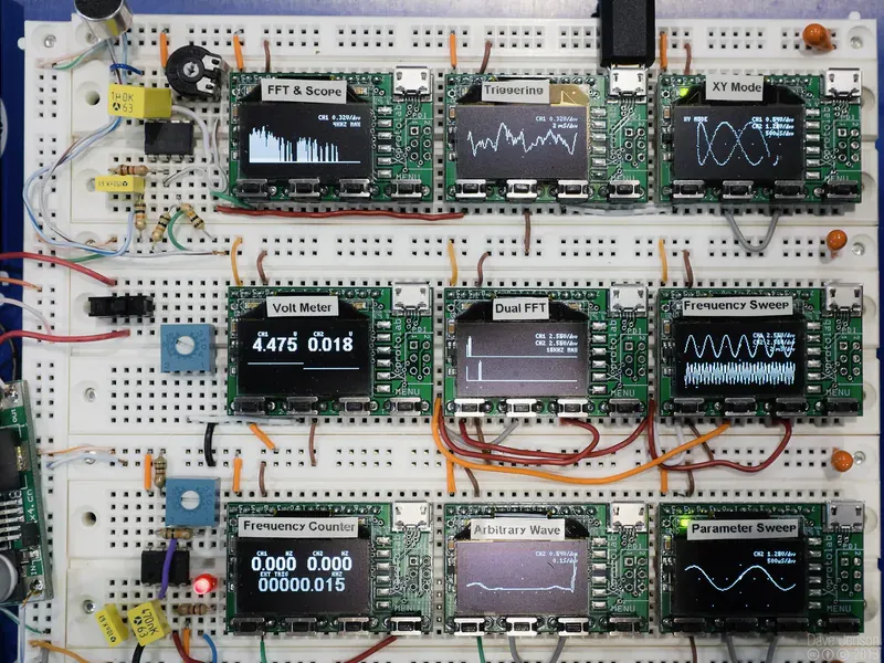 Compact oscilloscopes connected on an electronics breadboard