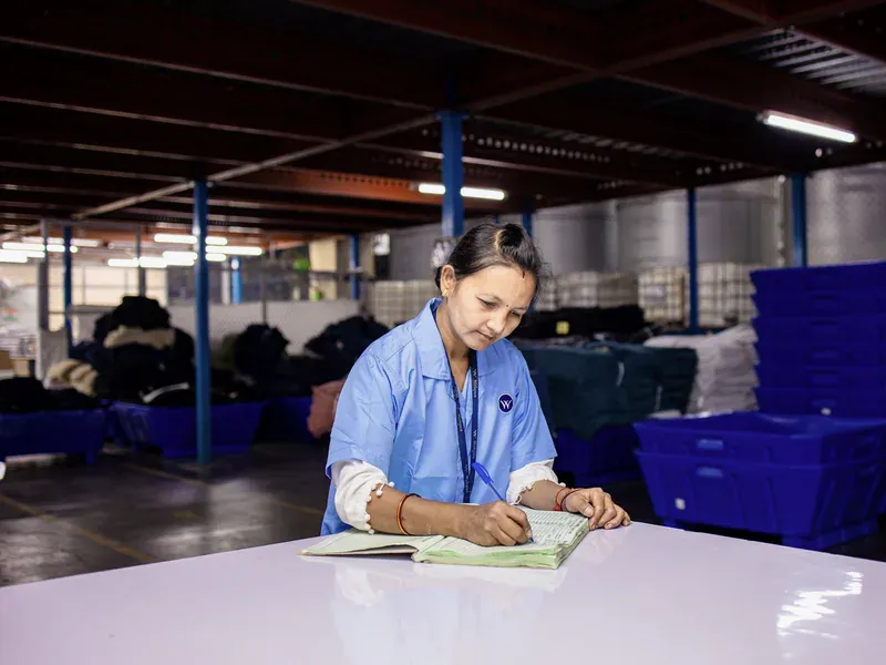 Warehouse worker recording storage observations in a log