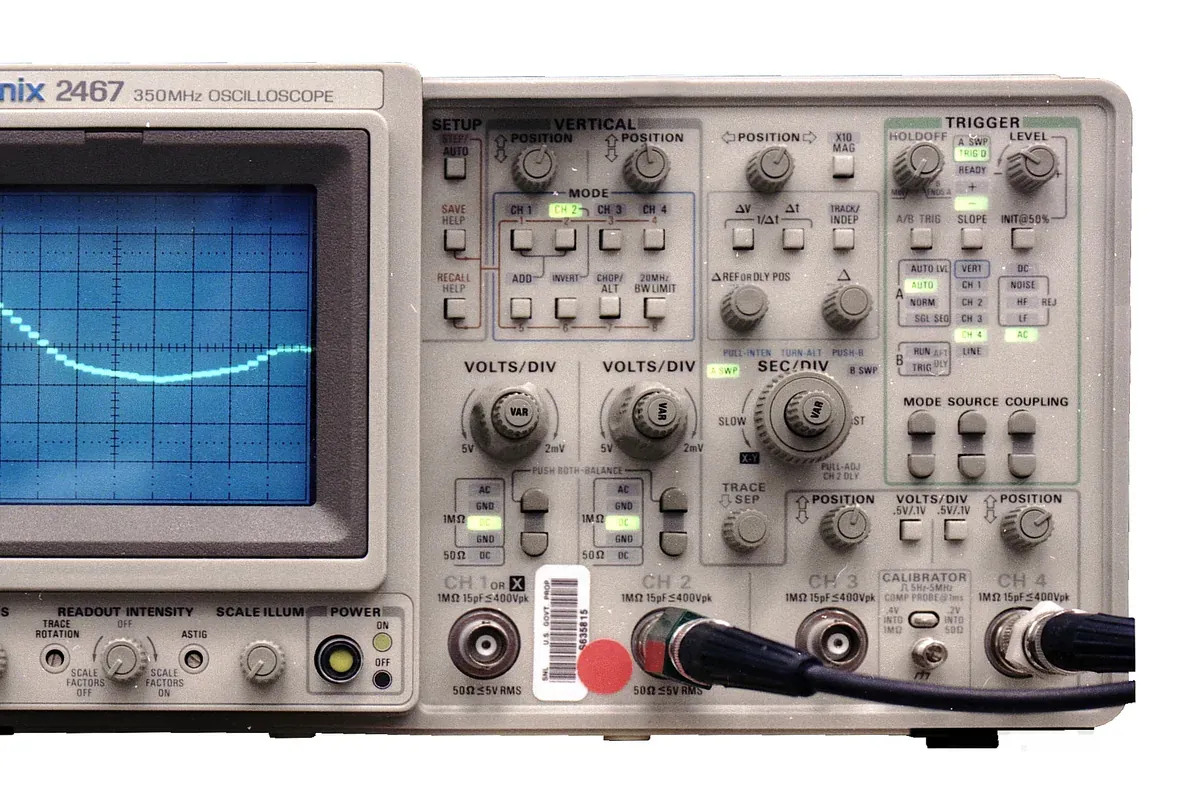 Engineer using an oscilloscope to validate multiple synchronized analog channels