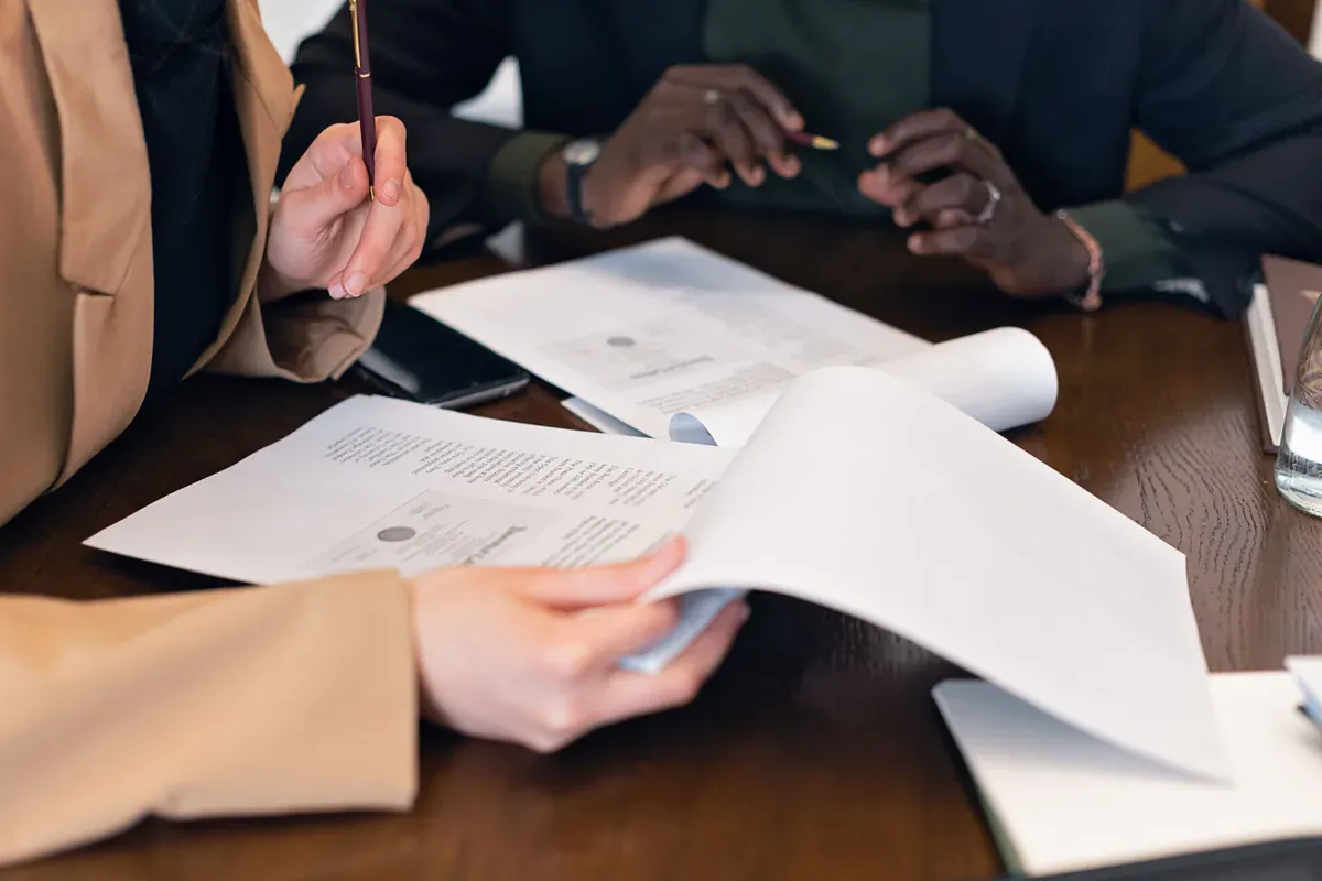 Procurement and quality professionals reviewing controlled documents together
