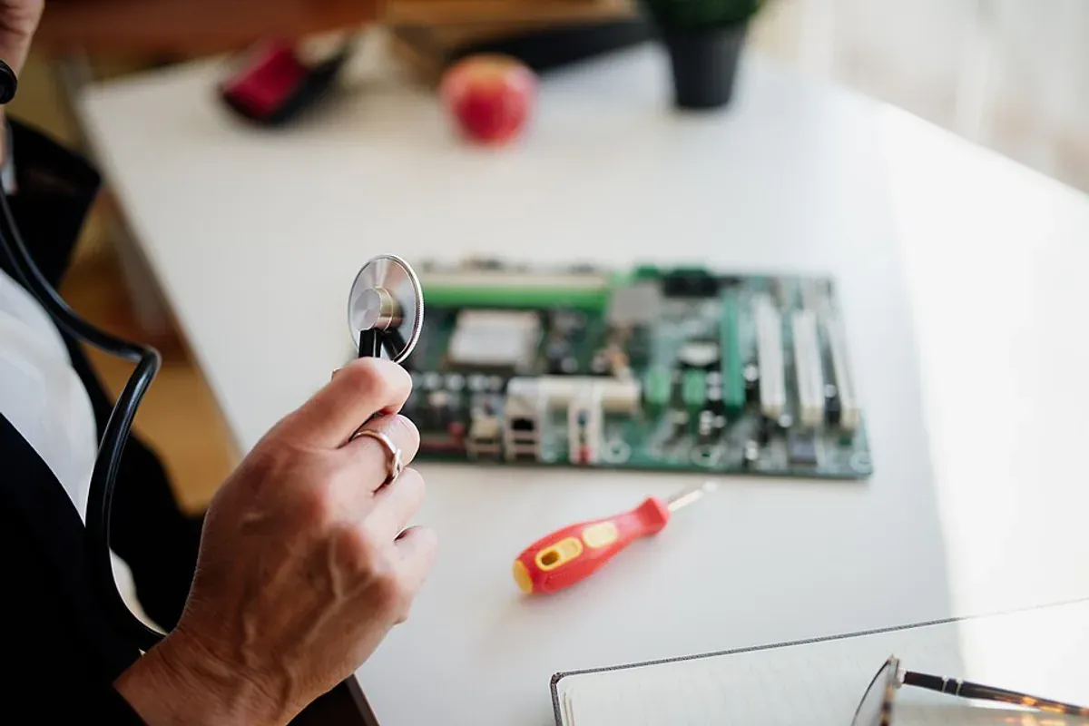 Technician repairing and testing a circuit board at a workbench