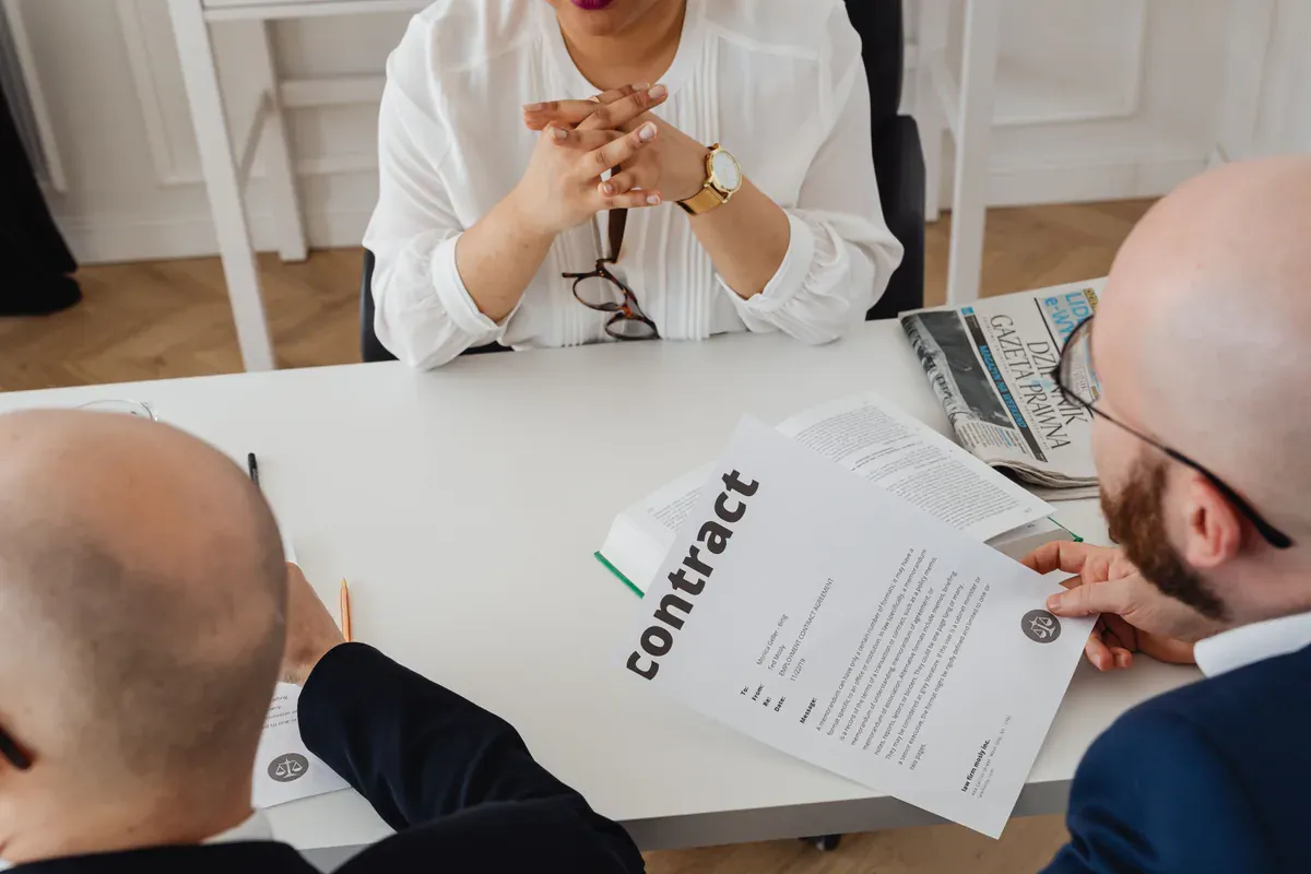 Procurement and manufacturing teams reviewing a sourcing agreement