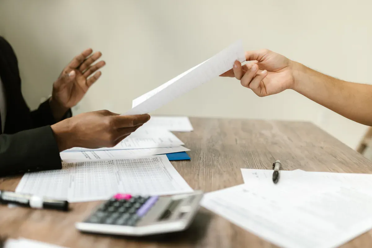Procurement professionals exchanging supplier contract documents