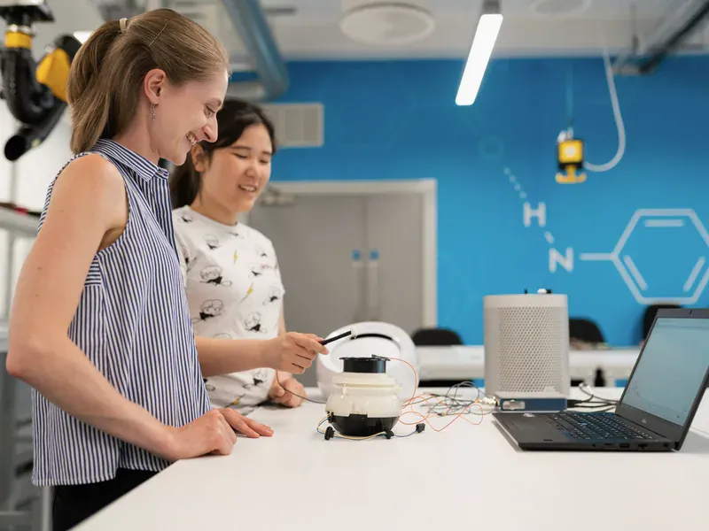 Engineers working with laboratory equipment during electronics research