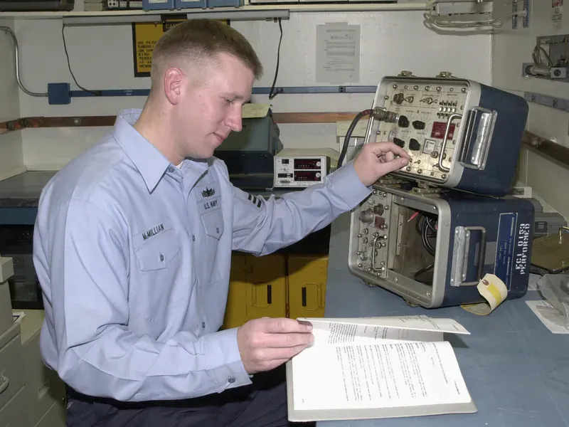 Technician completing an electronic bench test with laboratory instruments