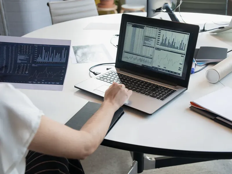 Procurement analyst working with digital data illustrating practical uses of AI-assisted sourcing