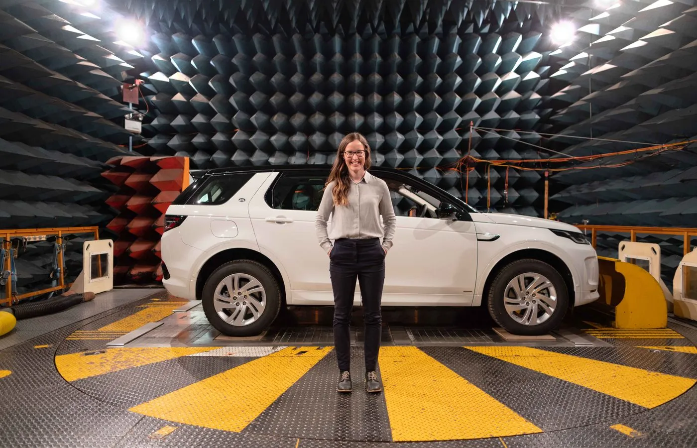 Vehicle undergoing electromagnetic compatibility testing in an anechoic chamber