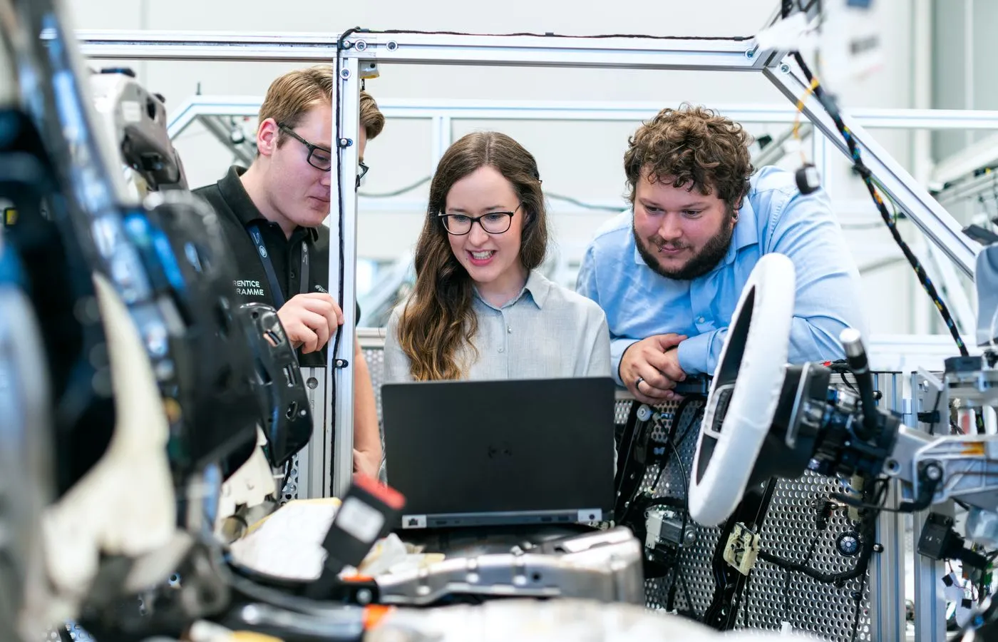 Automotive engineers working around an instrumented vehicle test setup