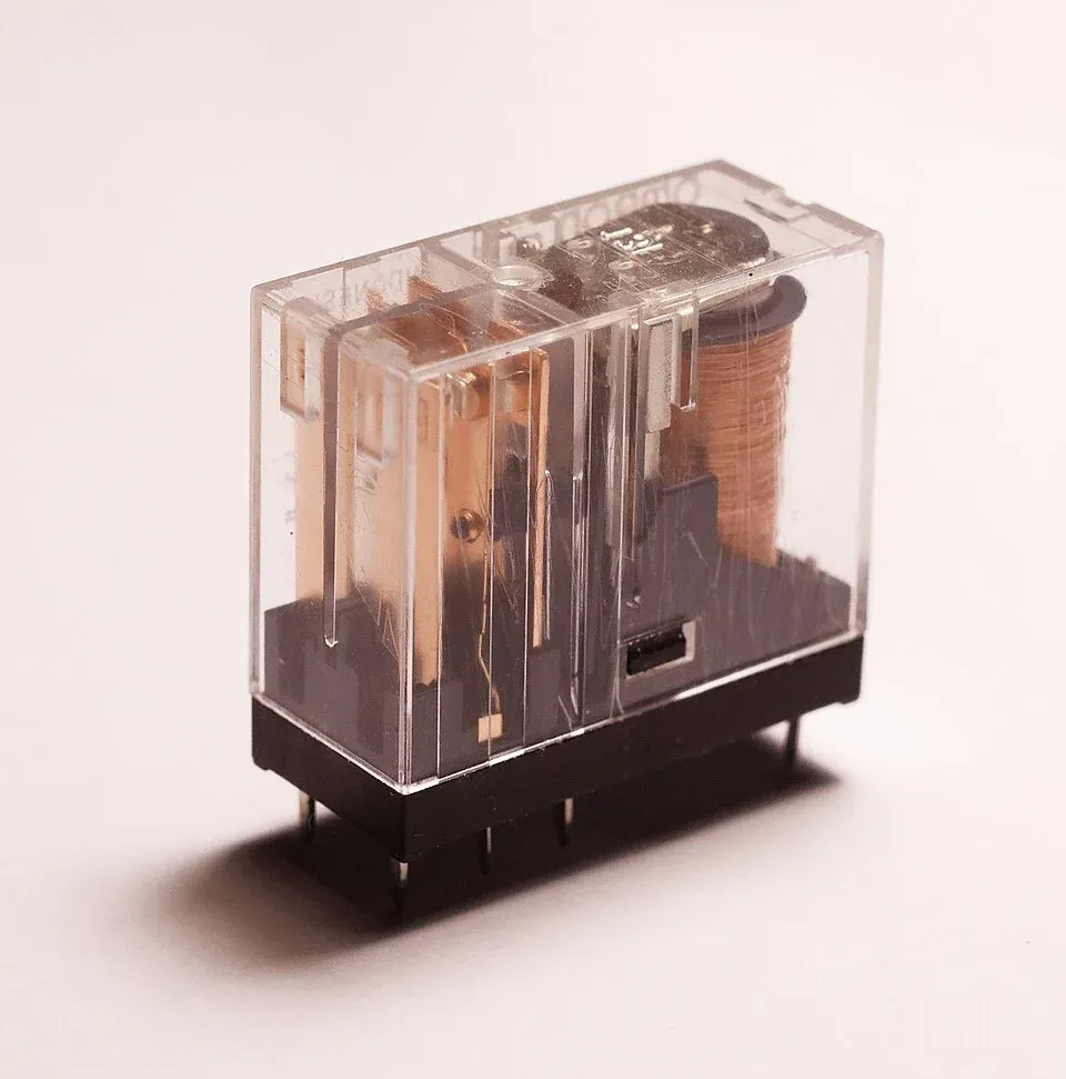 Transparent relay housing revealing its coil and contact mechanism