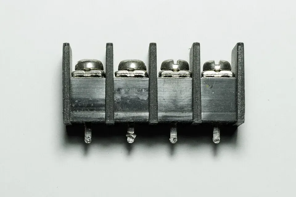 Terminal block underside showing solder pins and metal clamping connections