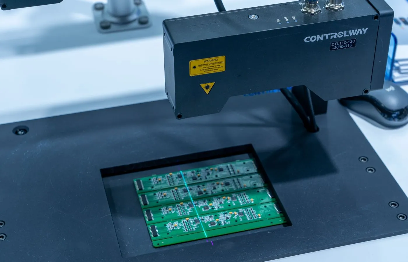 Automated inspection equipment scanning populated circuit boards
