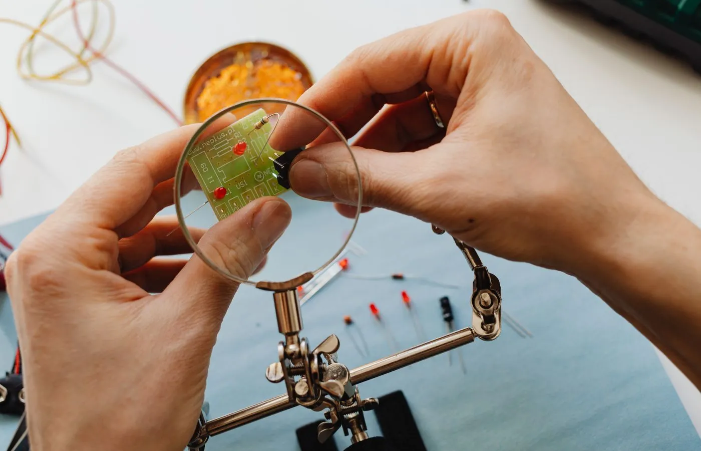Engineer examining electronic components through a magnifying lens