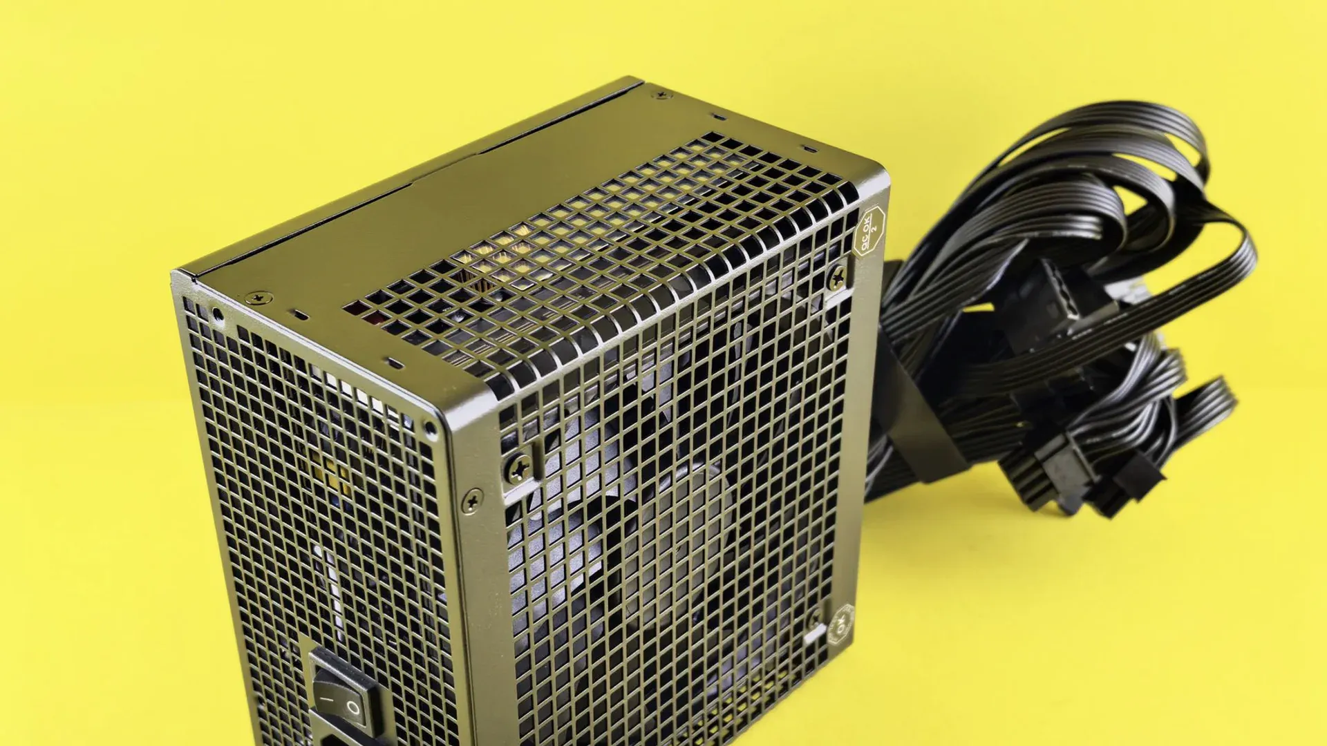Desktop power supply unit with bundled cables representing a protected power-input path