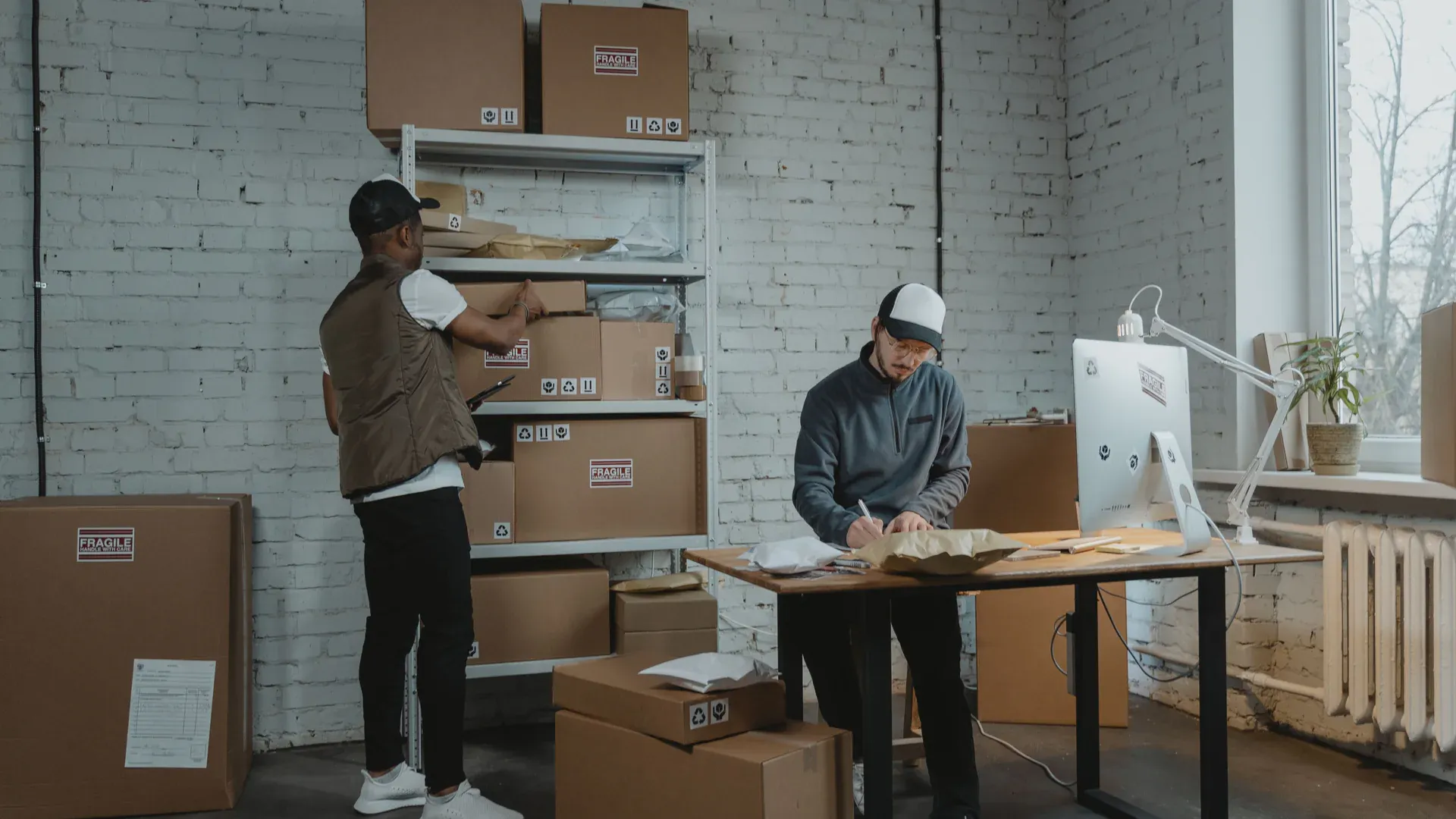 Logistics team processing packaged shipments in a warehouse office