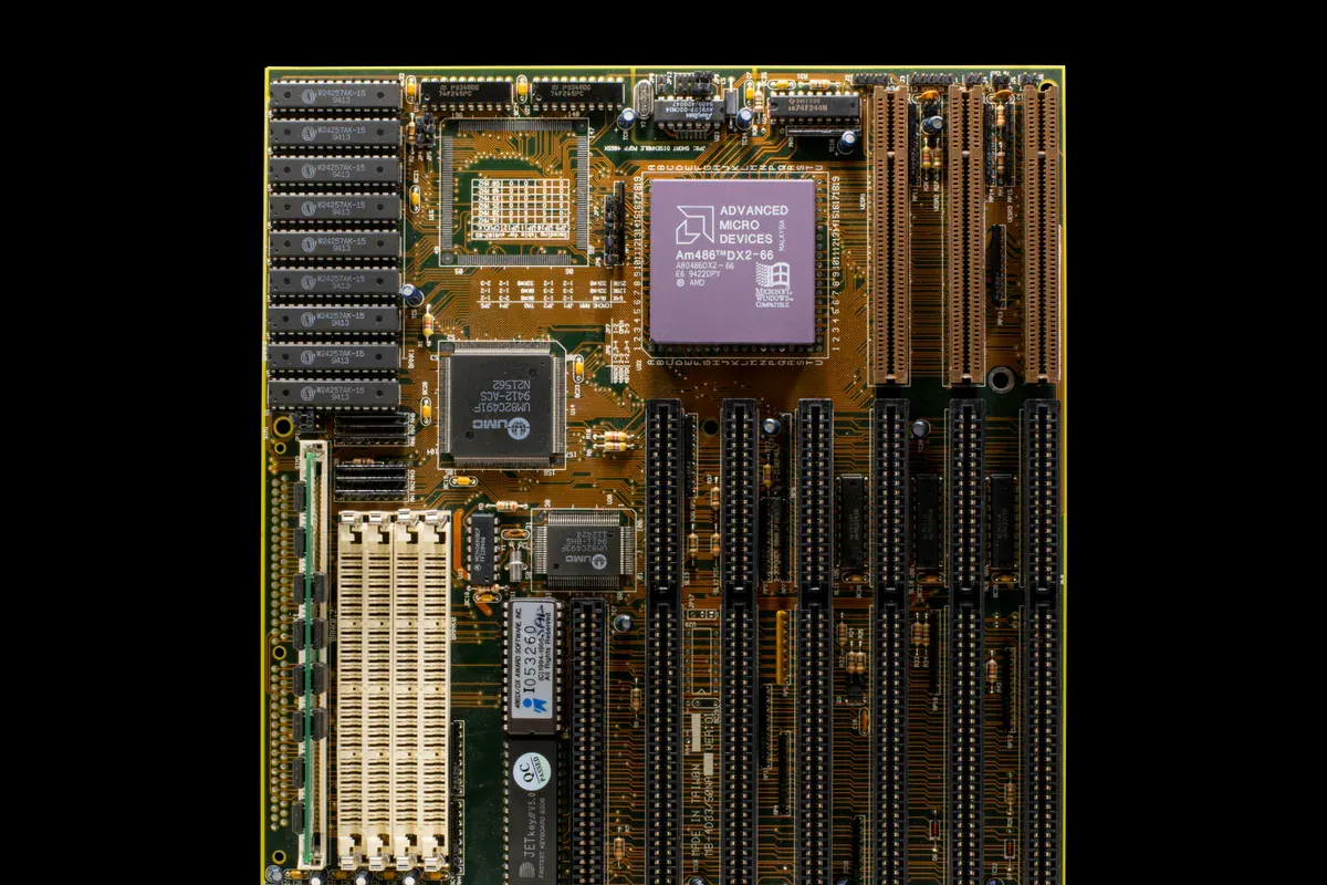 Older computer motherboard with socketed chips and expansion connectors