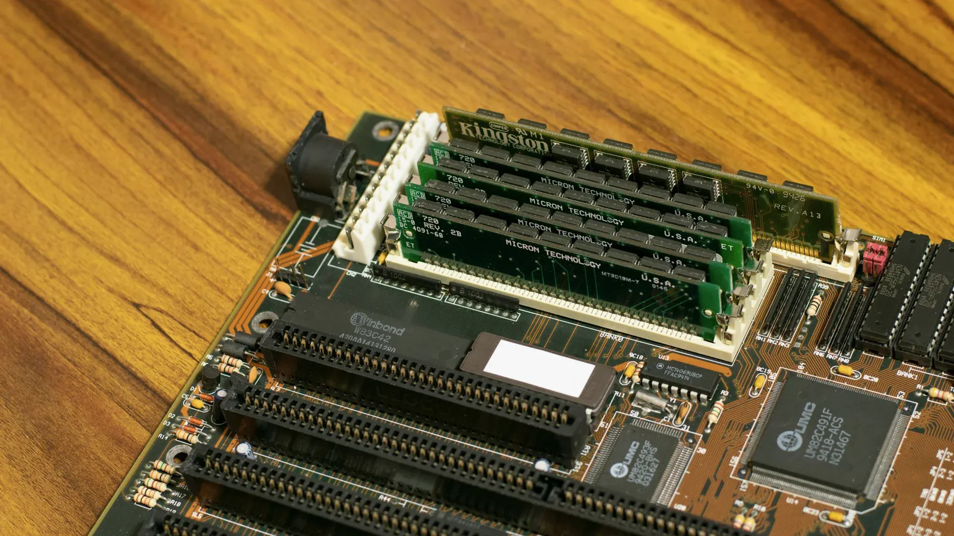 Vintage computer motherboard with installed memory modules illustrating persistent-memory hardware