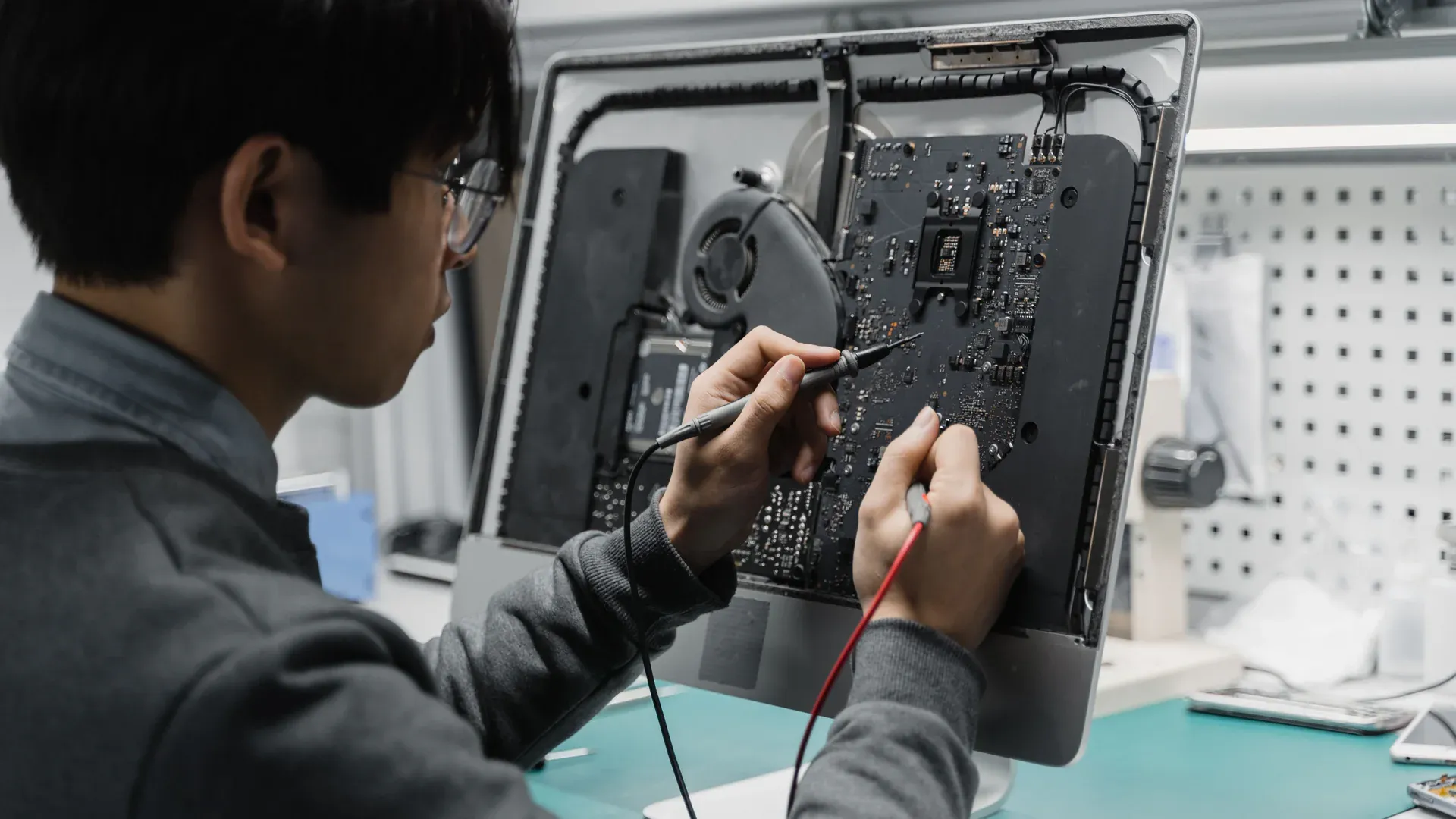 Technician organizing and inspecting electronic components at a workbench