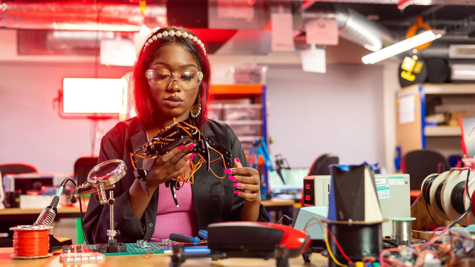 Engineer testing an IoT hardware prototype on an electronics workbench