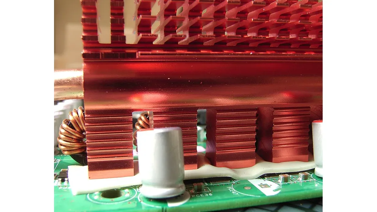 Compressible thermal gap pad bridging an electronic assembly and a copper heatsink