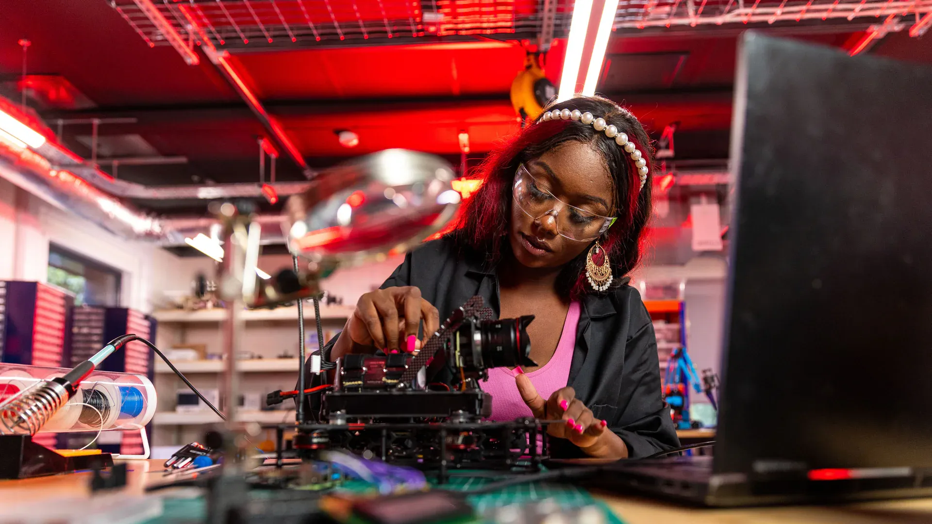 Electronics engineer inspecting a populated control board at a laboratory bench