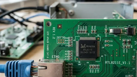 Realistic close-up of a networking microchip on a PCB with ethernet cable for Realtek Ethernet controller sourcing analysis