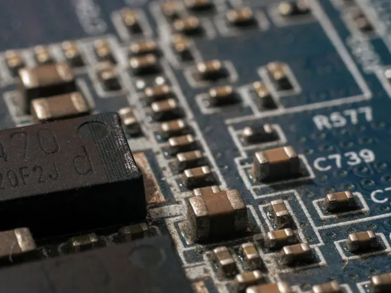 Electronic components on a circuit board representing the semiconductor categories that drive smart hardware BOM cost